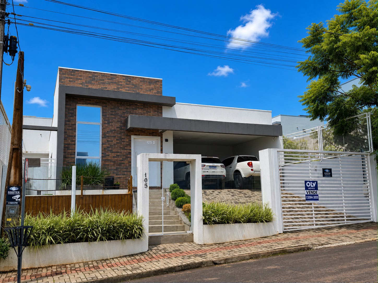 Fachada da casa com garagem coberta e jardim